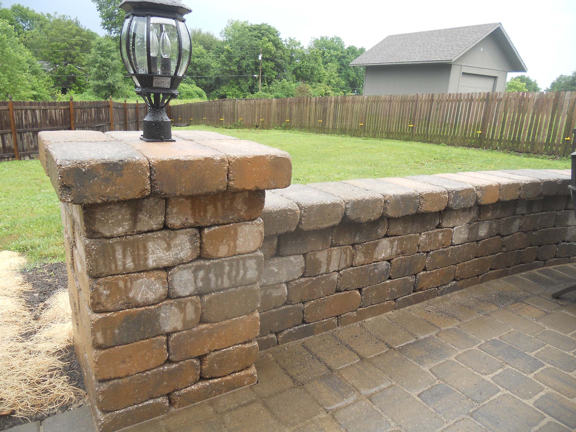 Outdoor low-voltage lighting on a stone patio built by Outlook Hardscape