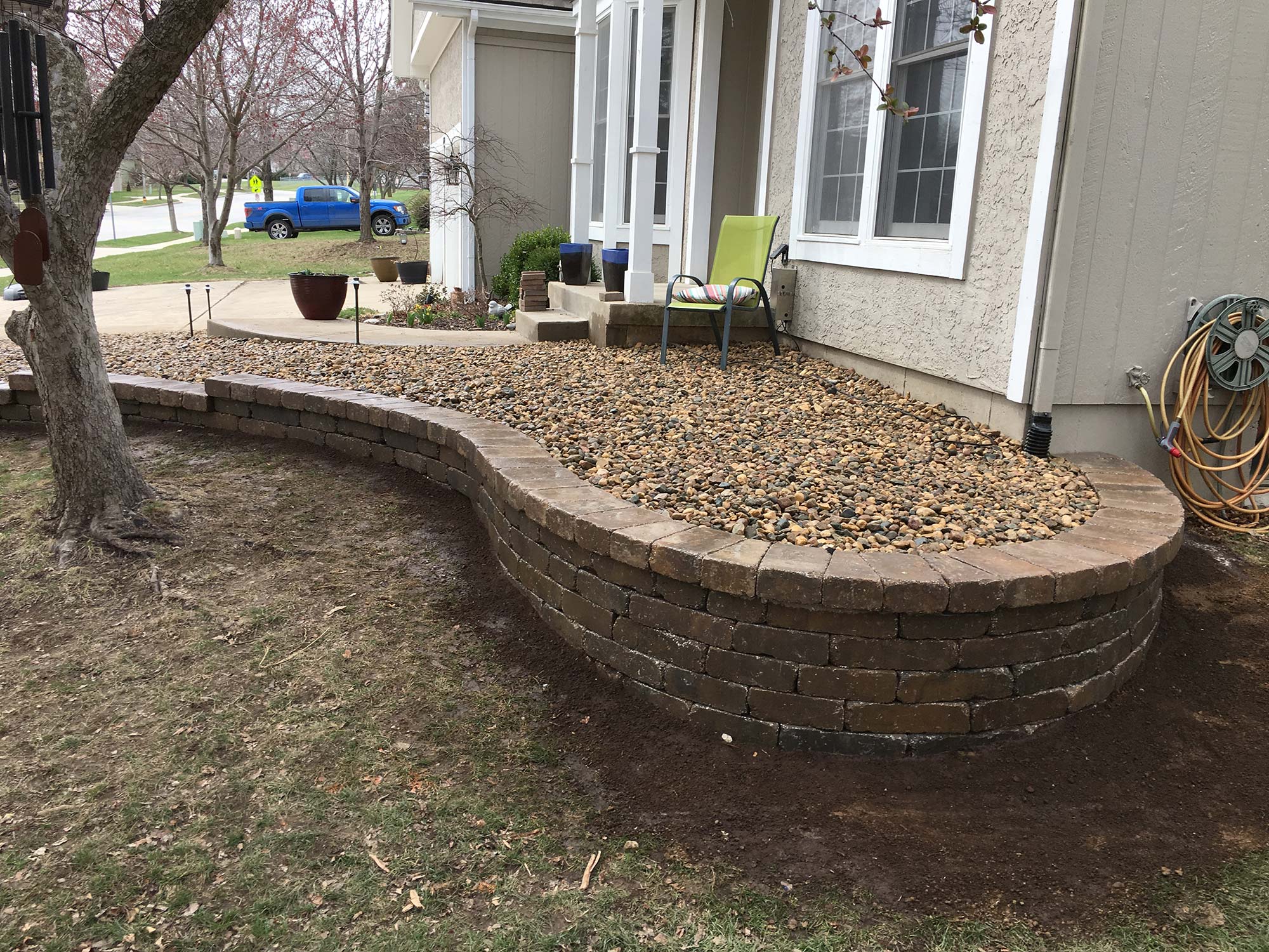 Natural stone retaining wall built by Outlook Hardscape